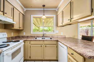 Kitchen featuring ornamental molding, under cabinet range hood, a sink, and white appliances
