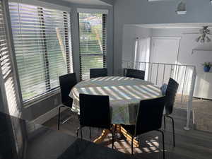 Dining room featuring wood finished floors, visible vents, a ceiling fan, and baseboards