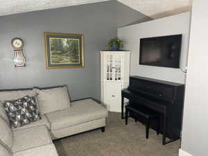 Living area featuring baseboards and carpet flooring