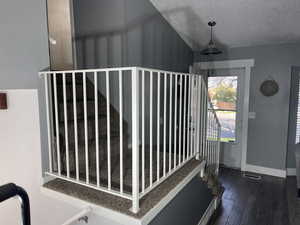 Interior space featuring visible vents, baseboards, and dark wood finished floors