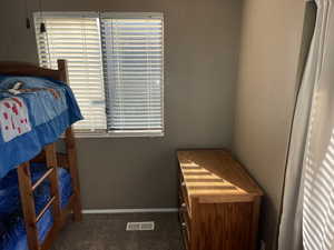 Bedroom # 2 with carpet, visible vents, and baseboards