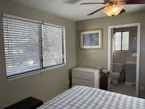 Tiled bedroom featuring a ceiling fan and connected bathroom