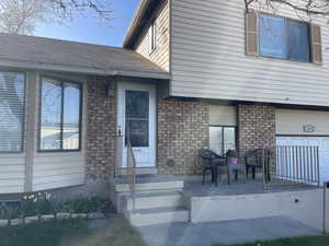 Front of house featuring a shingled roof and a garage
