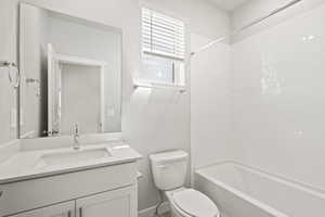 Full bath featuring vanity, bathing tub / shower combination, and toilet