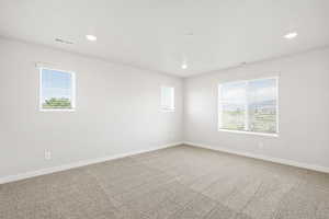 Unfurnished room with recessed lighting, carpet floors, and baseboards