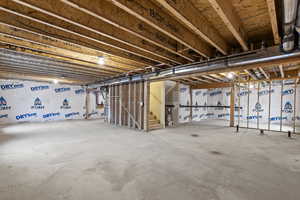 Unfinished basement featuring stairway