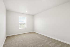 Carpeted empty room with baseboards and recessed lighting
