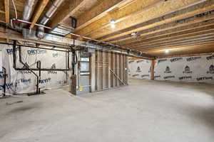Unfinished basement featuring heating unit