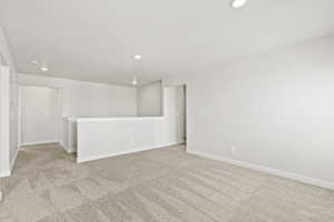 Carpeted loft featuring recessed lighting and baseboards