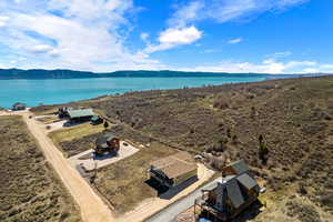 Drone / aerial view, space to park RV next to garage, concrete apron in front of garage and entry porch