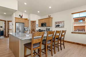 Kitchen with granite top and 4 barstools, recessed LED lighting throughout the home