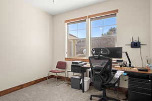 Carpeted 2nd bedroom  with ample closet, ceiling fan, and UV sunshades