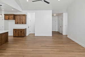Unfurnished living room featuring recessed lighting, light wood finished floors, a ceiling fan, and baseboards