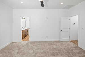 Unfurnished bedroom featuring ensuite bath, light carpet, visible vents, and baseboards