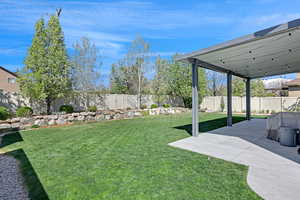 View of yard featuring a fenced backyard and a patio