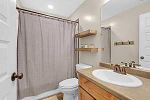 Full bathroom featuring vanity and toilet