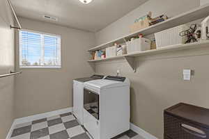 Laundry room with washing machine and clothes dryer, tile patterned floors, laundry area, baseboards, and visible vents
