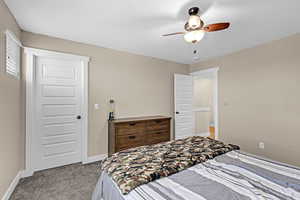 Bedroom featuring carpet floors, a ceiling fan, and baseboards