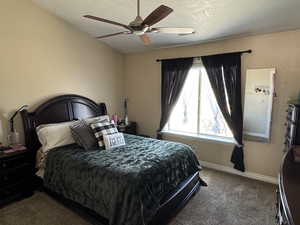 Bedroom with baseboards, carpet floors, and ceiling fan