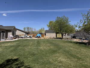 View of yard featuring fence, a patio area, and a playground