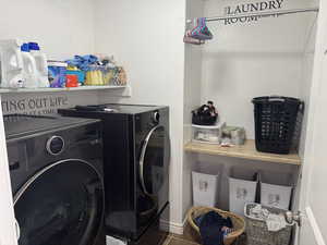 Laundry room with tile patterned floors, washer and dryer, and laundry area