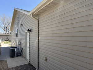 View of side of property with cooling unit