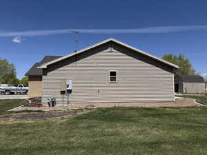 View of side of home featuring a yard
