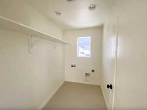Laundry room with hookup for a washing machine, electric dryer hookup, baseboards, laundry area, and recessed lighting