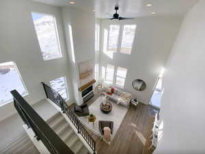 Living room featuring plenty of natural light, baseboards, and a towering ceiling