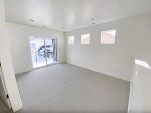 Empty room with baseboards, carpet flooring, and visible vents