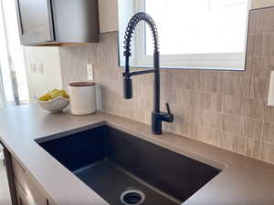 Interior details with decorative backsplash and a sink