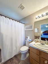Full bath with vanity, toilet, visible vents, tile patterned flooring, and ensuite bath