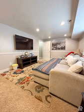 Carpeted bedroom with baseboards, visible vents, recessed lighting, and a textured ceiling