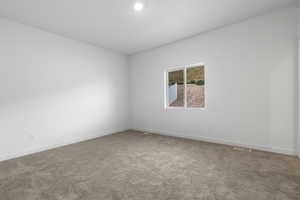 Carpeted spare room with baseboards and visible vents