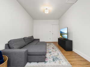 Living area featuring light wood-type flooring and baseboards