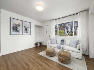 Living area with baseboards and wood finished floors
