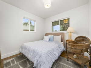 Bedroom with wood finished floors and baseboards