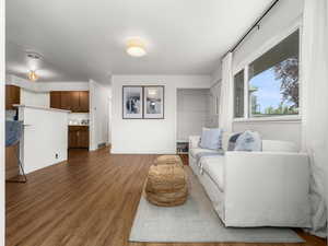 Living room featuring baseboards, visible vents, and dark wood-style floors