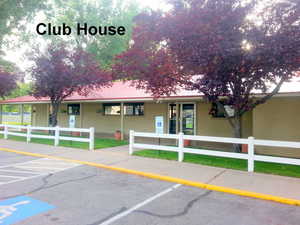View of property featuring uncovered parking and a fenced front yard