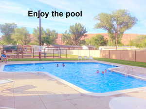 Pool featuring a patio and fence