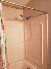 2nd full bathroom with shower / bath combination with curtain