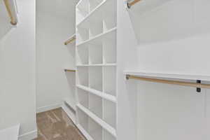 Owner's Suite Walk in closet featuring carpet floors