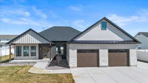 Modern farmhouse style home with fence, board and batten siding, an attached garage, driveway, and covered porch