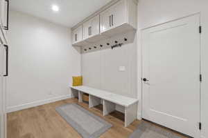 Mudroom with baseboards and light wood-style floors