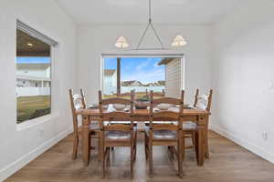 Dining area with light wood-style flooring and baseboards