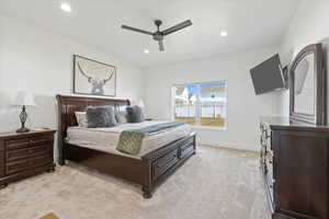 Owner's Suite Bedroom with baseboards, light carpet, and recessed lighting