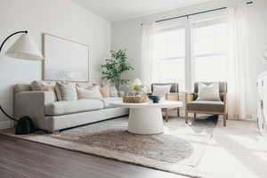 Living area featuring baseboards and wood finished floors