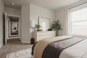 Bedroom featuring light carpet and baseboards