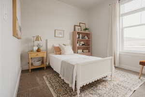 Carpeted bedroom featuring baseboards