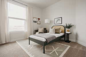 Bedroom with baseboards and carpet